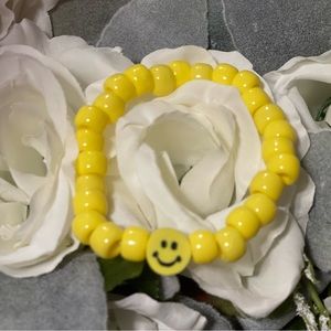 Yellow beaded bracelet, smiley face